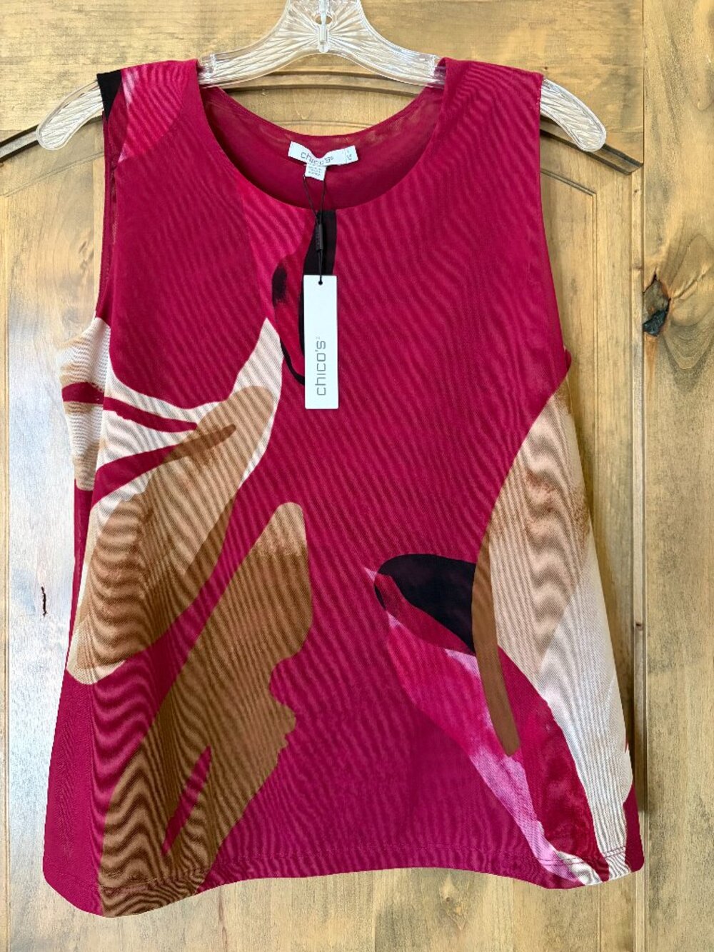 New with tags-Gorgeous pullover top. Full lined. Chicos size 1-medium-Flattering